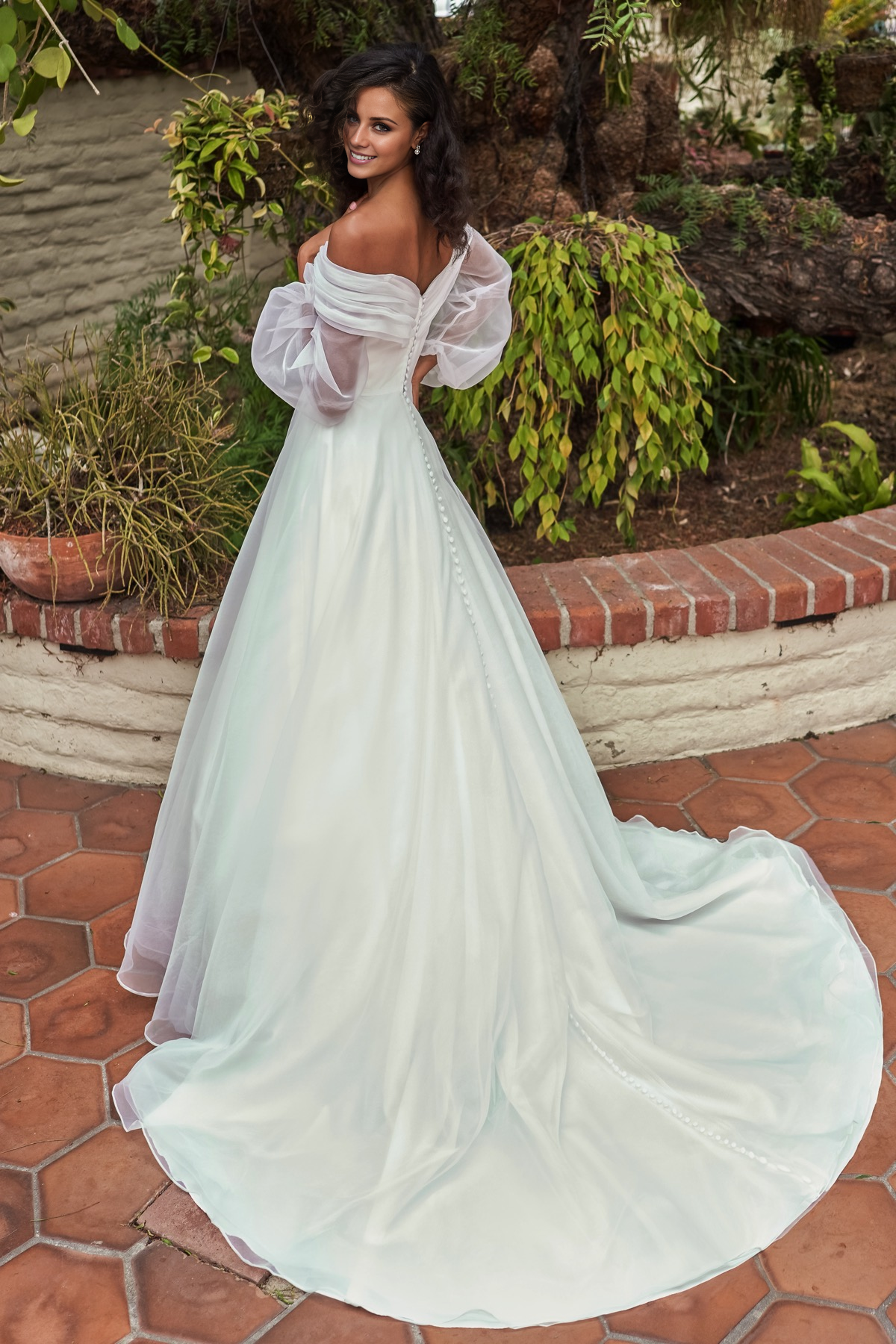 V-neckline slim fit waistline long sleeved and floor length wedding dress