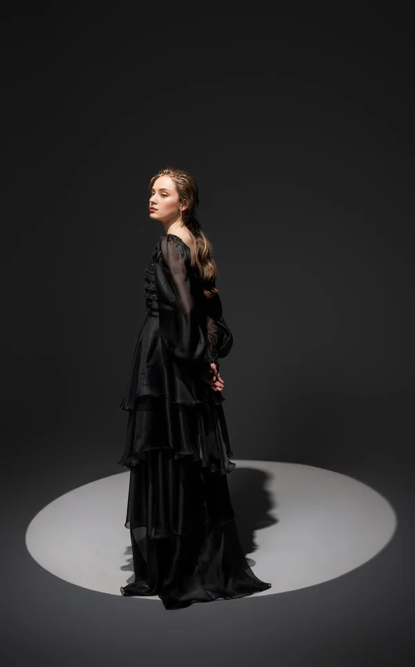 Tight fitting top paired with thin shoulder straps Prom ress