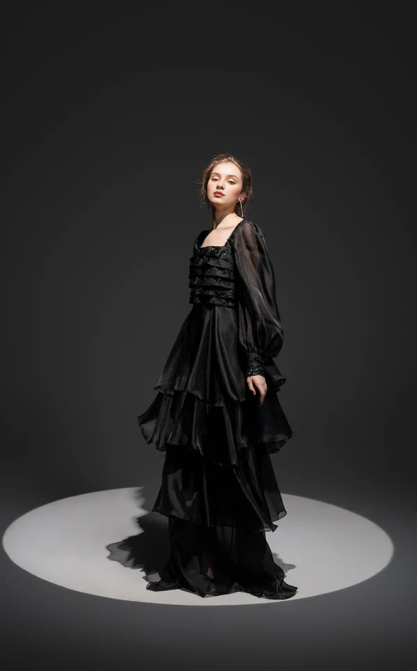 Tight fitting top paired with thin shoulder straps Prom ress